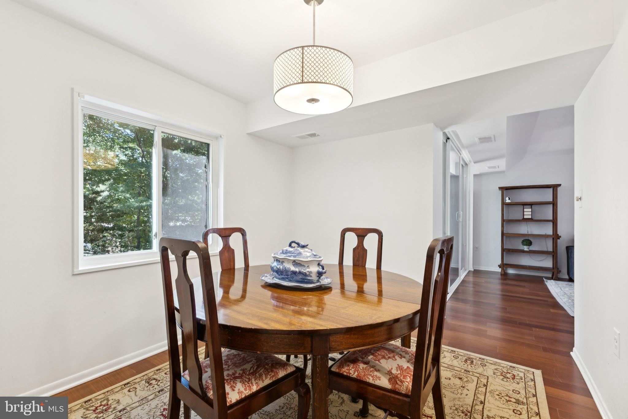 1413 Northgate Square, Unit 13/12B Reston, VA 20190 - Photo 9 of 25 a view of a dining room with furniture window and wooden floor