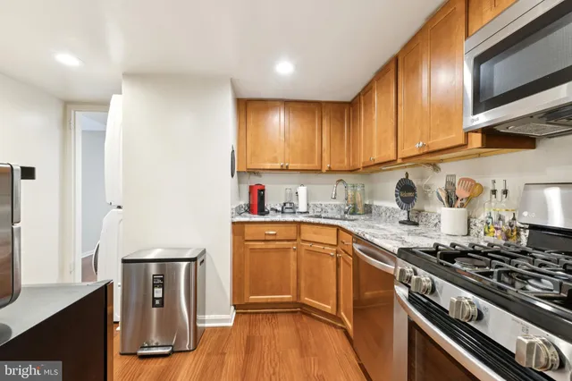 a kitchen with granite countertop a stove and a sink