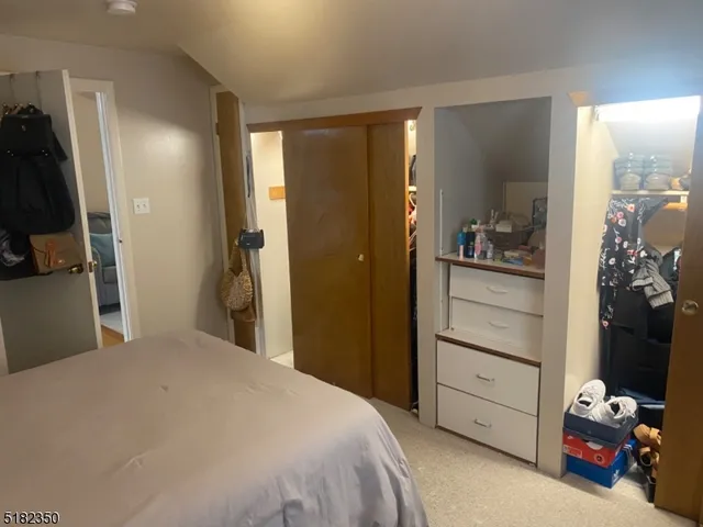 a bedroom with a bed and a mirror