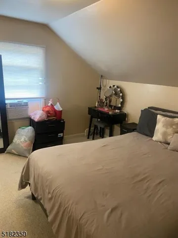 a bedroom with bed and mirror