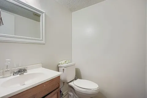 a white toilet sitting next to a bathroom sink