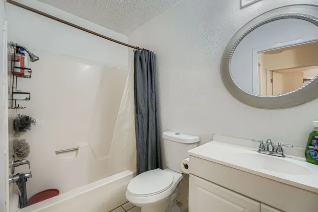 a white toilet sitting next to a bathroom sink
