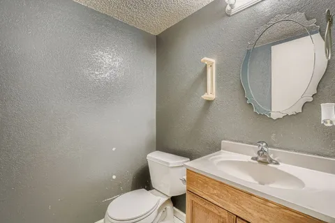 a bathroom with a sink mirror and toilet