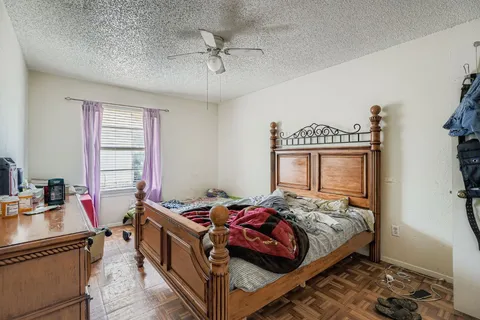 a bedroom with a bed and a chandelier