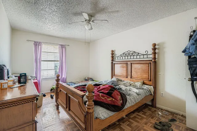 a bedroom with a bed and a chandelier