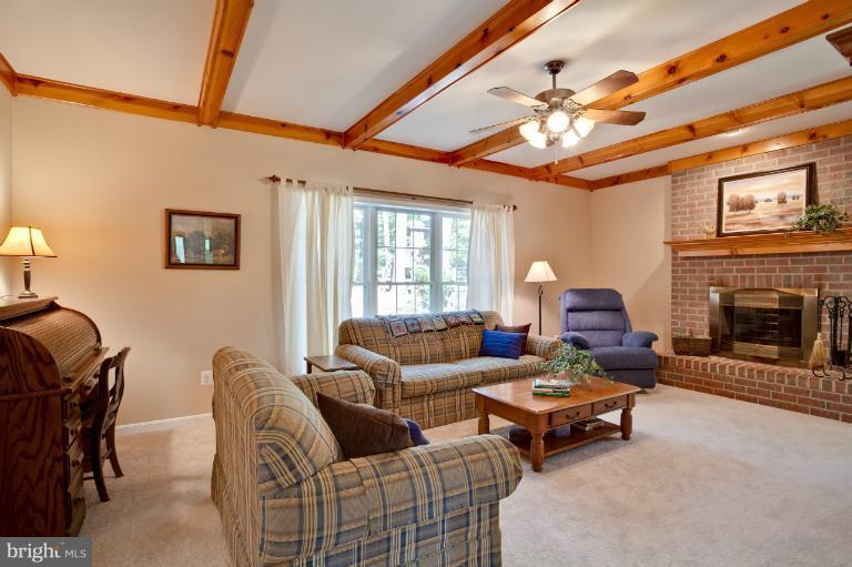 13415 Fork Road Baldwin, MD 21013 - Photo 15 of 29 a living room with furniture a fireplace and a flat screen tv