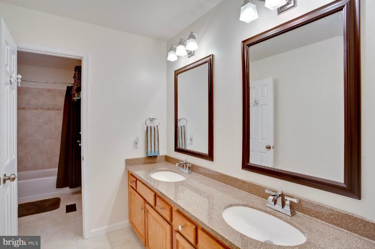13415 Fork Road Baldwin, MD 21013 - Photo 26 of 29 a bathroom with double vanity and a mirror