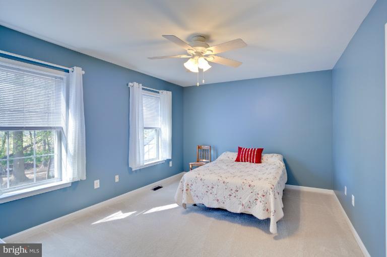 13415 Fork Road Baldwin, MD 21013 - Photo 5 of 29 a bedroom with a bed and a chandelier