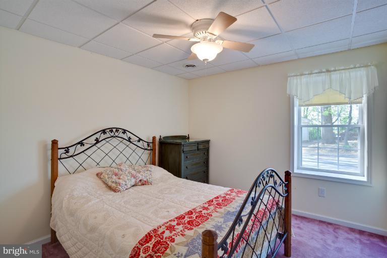 13415 Fork Road Baldwin, MD 21013 - Photo 8 of 29 a bedroom with a bed and a chandelier