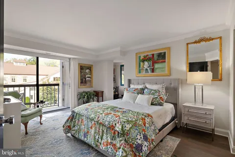 a bedroom with bed and large windows