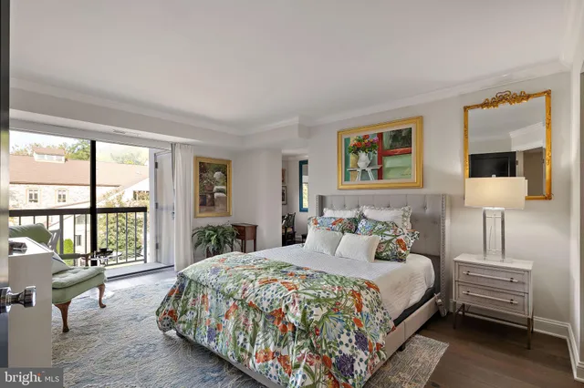 a bedroom with bed and large windows