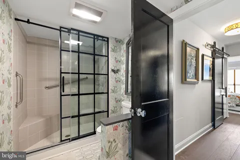 a bathroom with a glass shower door