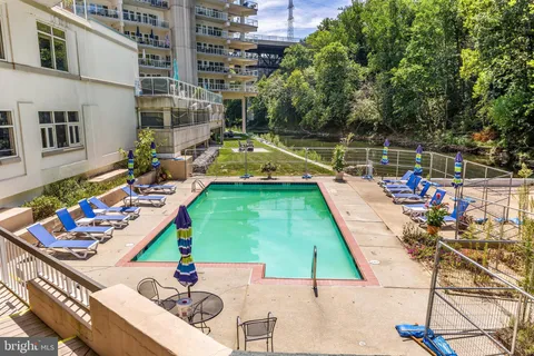 a view of a swimming pool with lounge chairs