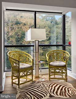 a view of a chairs and a table in the balcony