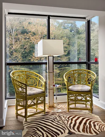 a view of a chairs and a table in the balcony