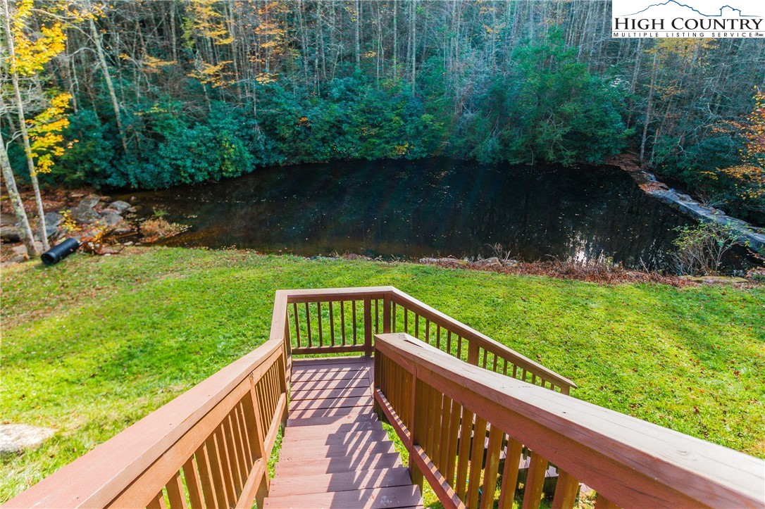 3654 Andy Hicks Road Banner Elk, NC 28604 - Photo 22 of 40 a view of a wooden deck with a yard