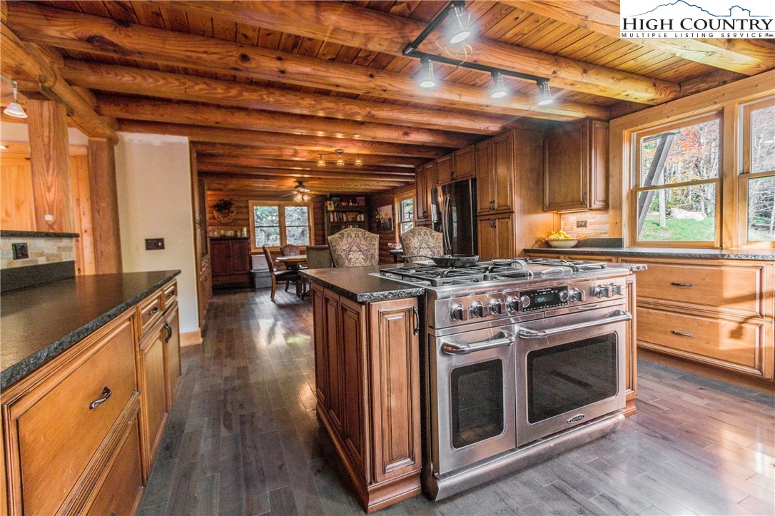 3654 Andy Hicks Road Banner Elk, NC 28604 - Photo 28 of 40 a kitchen with stainless steel appliances granite countertop a stove and a wooden floors