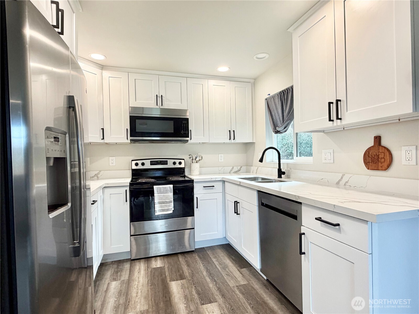 1608 South Evans Street Aberdeen, WA 98520 - Photo 7 of 20 a kitchen with stainless steel appliances a stove a sink and a refrigerator