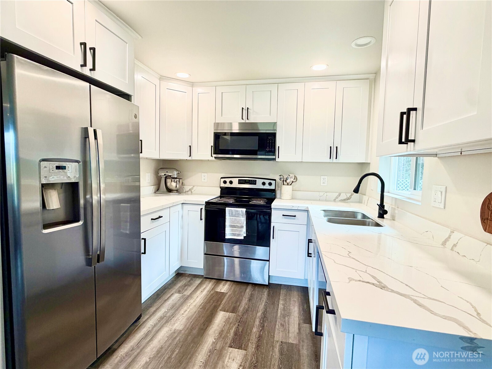1608 South Evans Street Aberdeen, WA 98520 - Photo 8 of 20 a kitchen with stainless steel appliances granite countertop a refrigerator and a stove top oven
