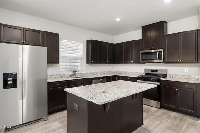 a kitchen with a sink and a stove top oven