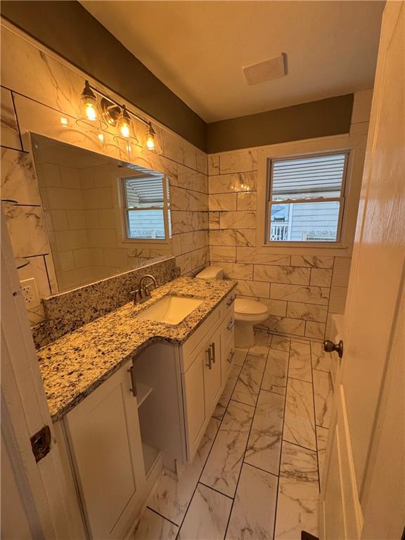 649 Valley Brook Road Scottdale, GA 30079 - Photo 12 of 18 a bathroom with a granite countertop sink a mirror and a shower