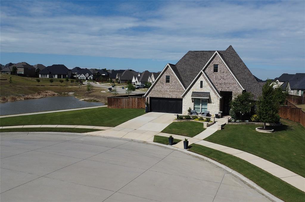 582 Broadleaf Way Haslet, TX 76052 - Photo 2 of 40 Beautiful curb appeal, meticulously maintained yard. Custom stone work at front porch and walk way. Brick and stone exterior, cul de sac, extra long driveway. Tandem 3 car garage. Home sits at the end of the cul de sac next to neighborhood pond for added privacy.