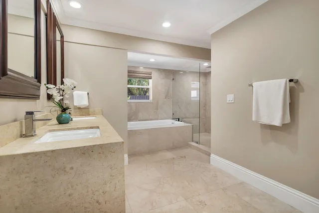 a bathroom with a tub sink and mirror