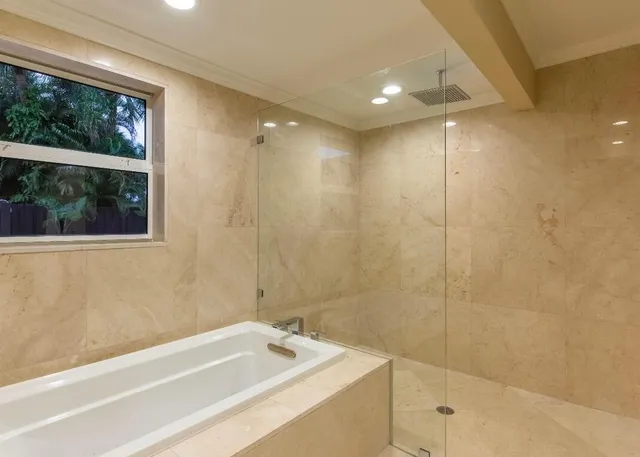 a bathroom with a bathtub and shower