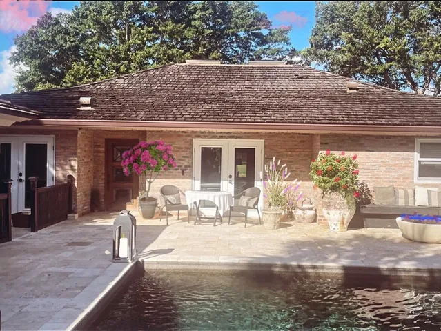 a front view of a house with outdoor seating