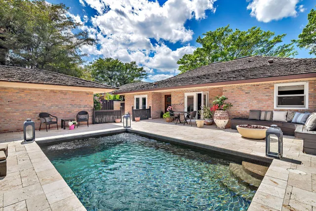 a view of a swimming pool with chairs
