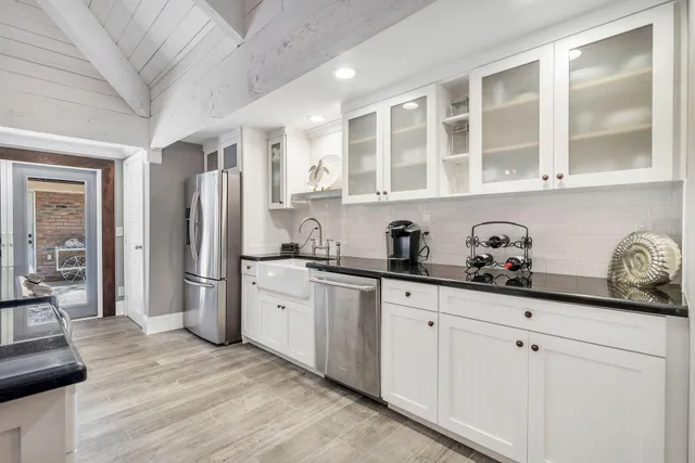a kitchen with stainless steel appliances granite countertop a refrigerator and cabinets