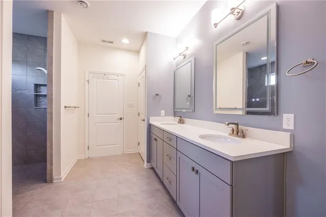 a spacious bathroom with a double vanity sink mirror and double
