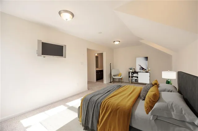 a bedroom with a bed and a night stand