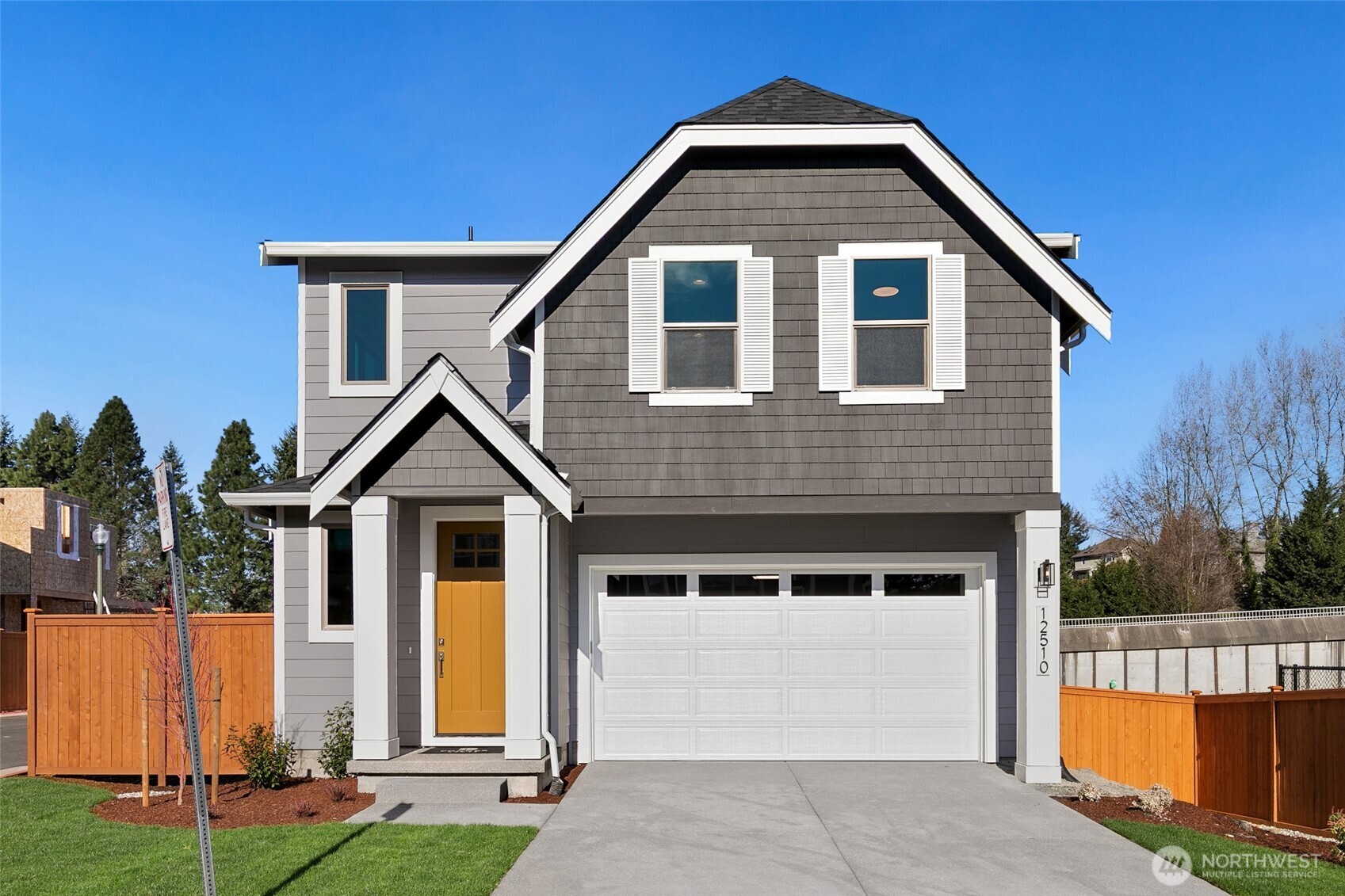 12510 Southeast 256th Place, Unit 7 Kent, WA 98030 - Photo 1 of 39 a front view of a house with a yard
