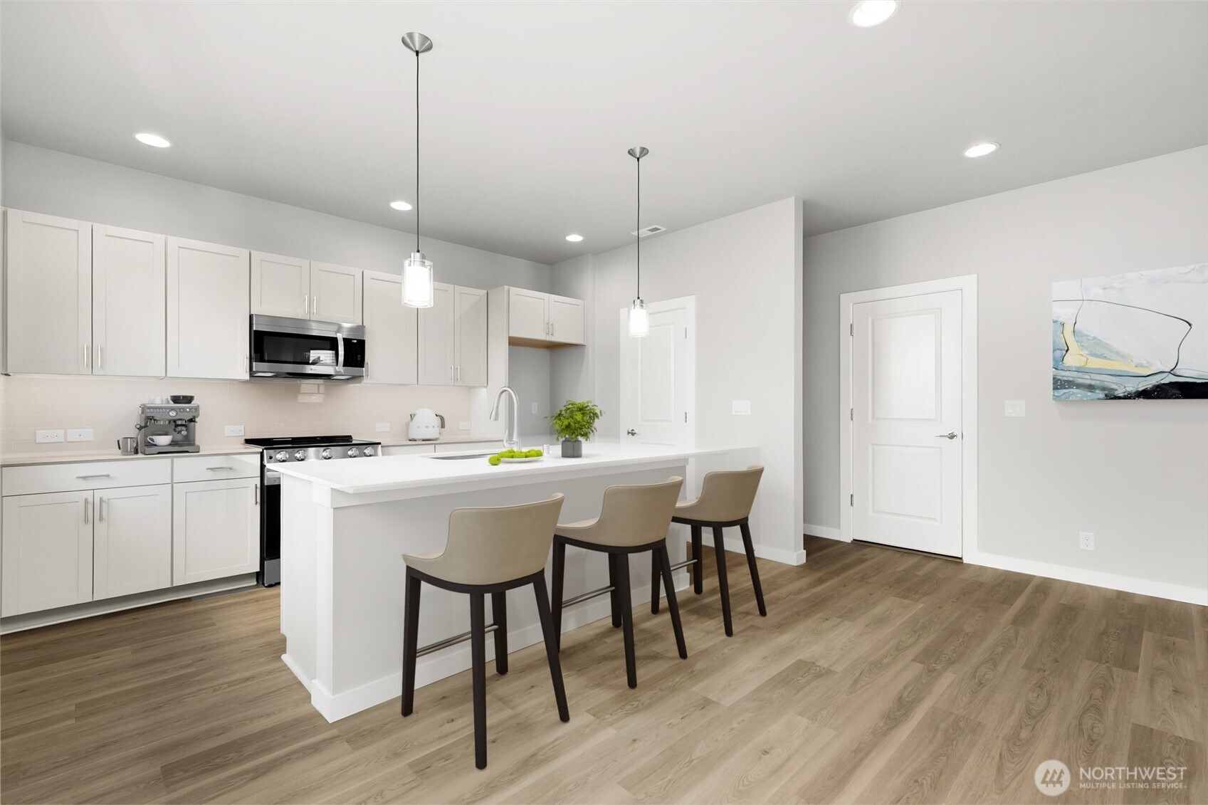 12510 Southeast 256th Place, Unit 7 Kent, WA 98030 - Photo 14 of 39 a kitchen with kitchen island granite countertop a sink a counter space stainless steel appliances and cabinets