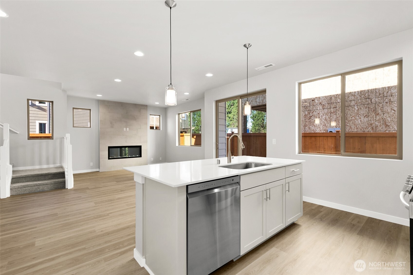 12510 Southeast 256th Place, Unit 7 Kent, WA 98030 - Photo 17 of 39 a kitchen with a sink stove and wooden floor