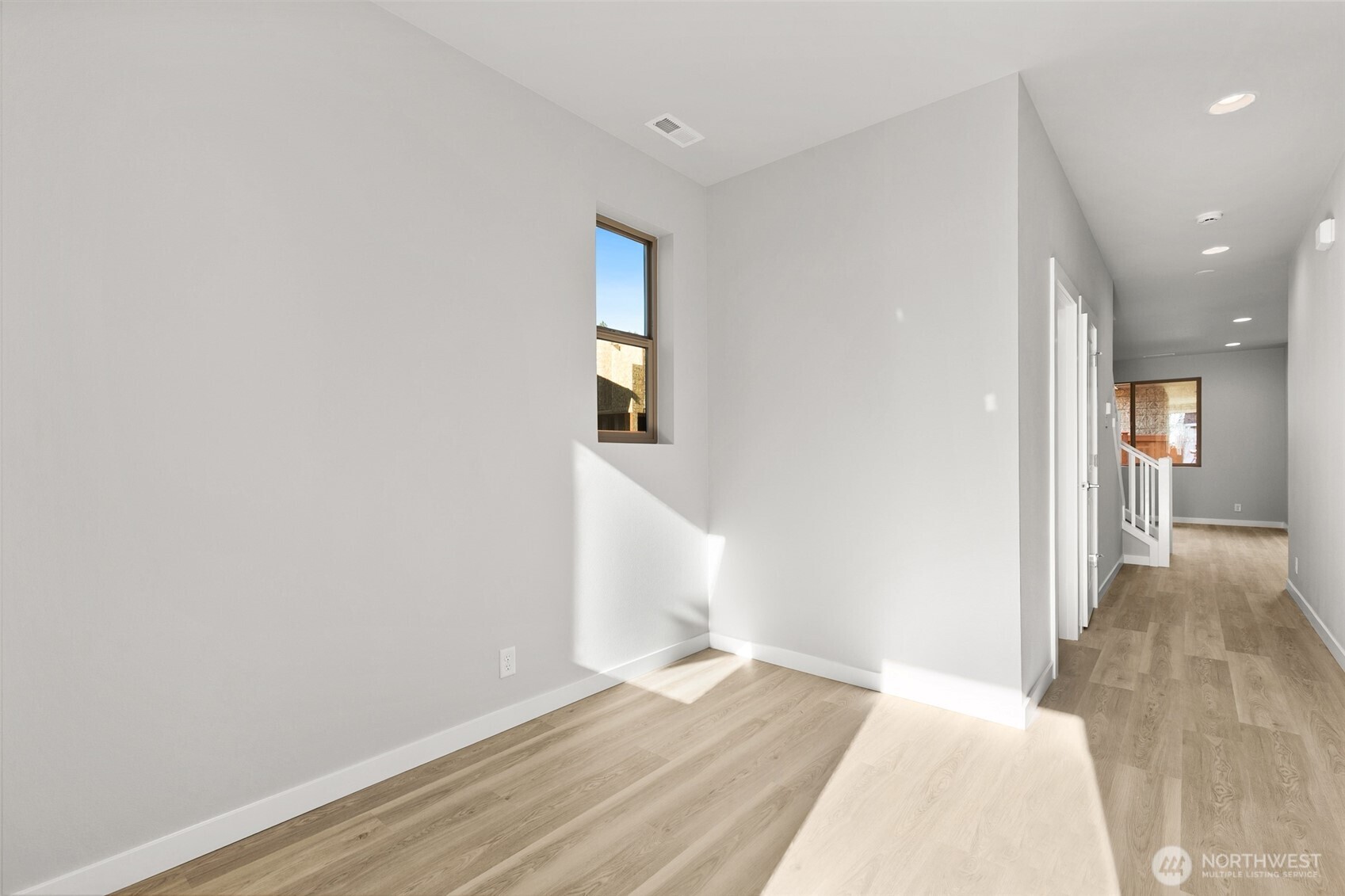 12510 Southeast 256th Place, Unit 7 Kent, WA 98030 - Photo 2 of 39 a view of a room with wooden floor and entryway