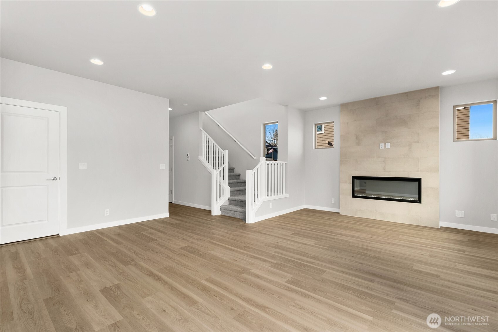 12510 Southeast 256th Place, Unit 7 Kent, WA 98030 - Photo 4 of 39 a view of an empty room with wooden floor and a window