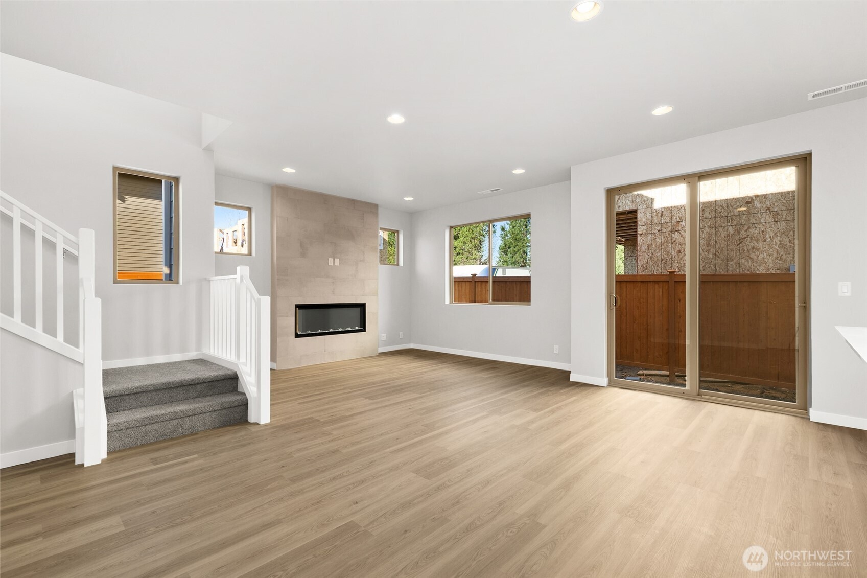 12510 Southeast 256th Place, Unit 7 Kent, WA 98030 - Photo 7 of 39 an empty room with wooden floor and a fireplace