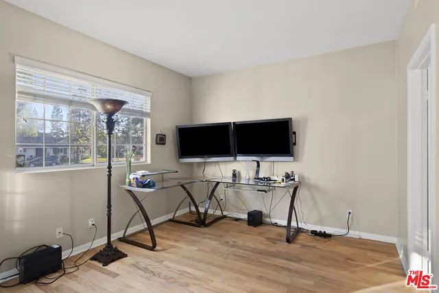 a view of a livingroom with workspace and a window