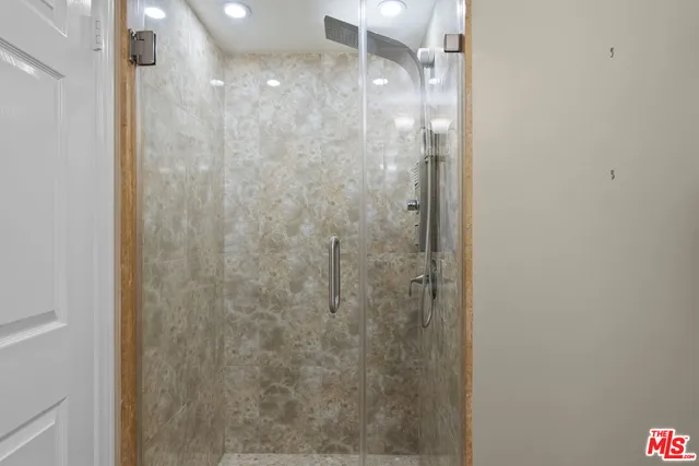 a bathroom with a glass shower door