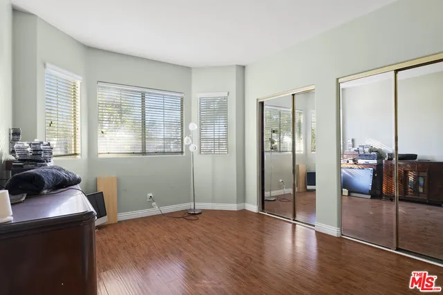 a view of a livingroom with wooden floor and furniture