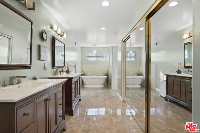 a spacious bathroom with a shower sink and mirror