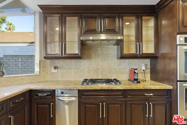 a kitchen with stainless steel appliances granite countertop a sink and cabinets