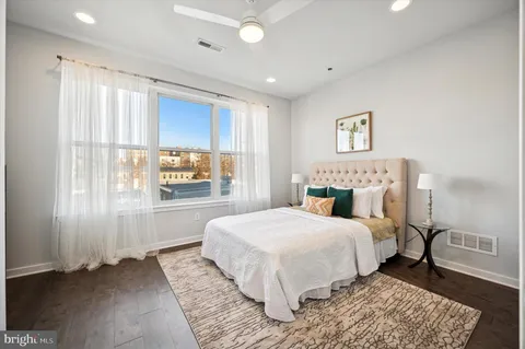 a bedroom with a large bed and a window