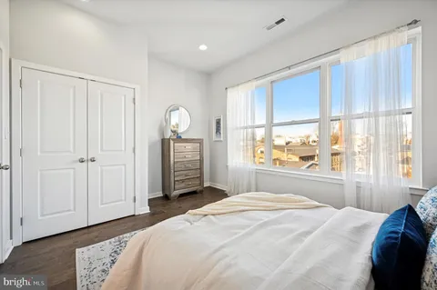 a bedroom with a large bed and a large window