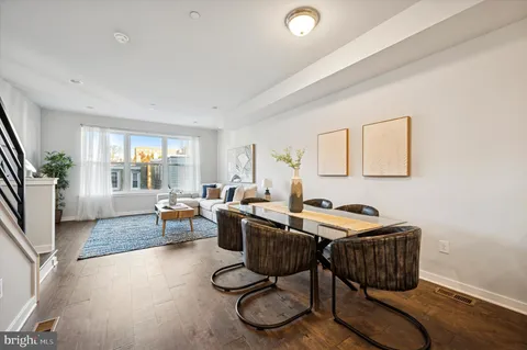 a living room with furniture a rug and a window