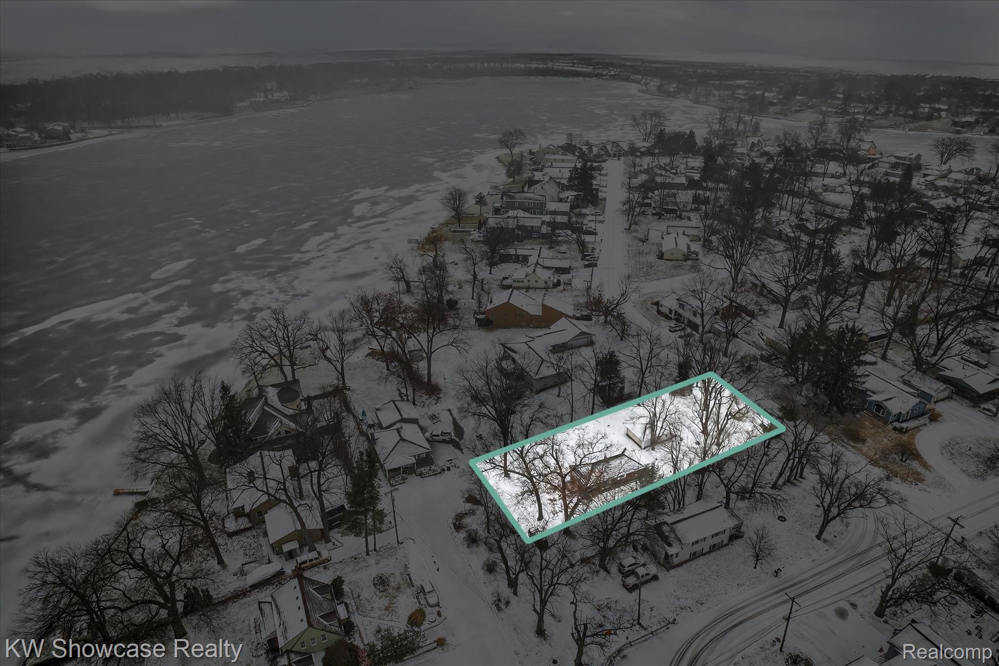 Aerial view of property and surrounding area with property parcel outlined