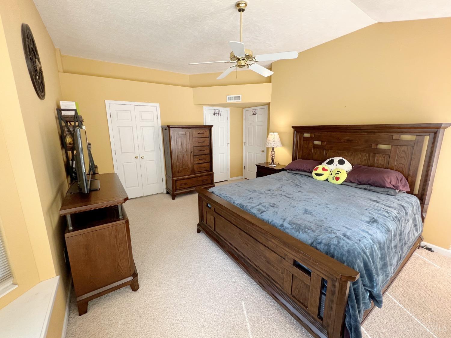 8408 Ridge Pointe Court, Unit 13 Reading, OH 45237 - Photo 11 of 39 Check out this primary bedroom with carpeting, cathedral ceiling, ceiling fan and adjoining bathroom.