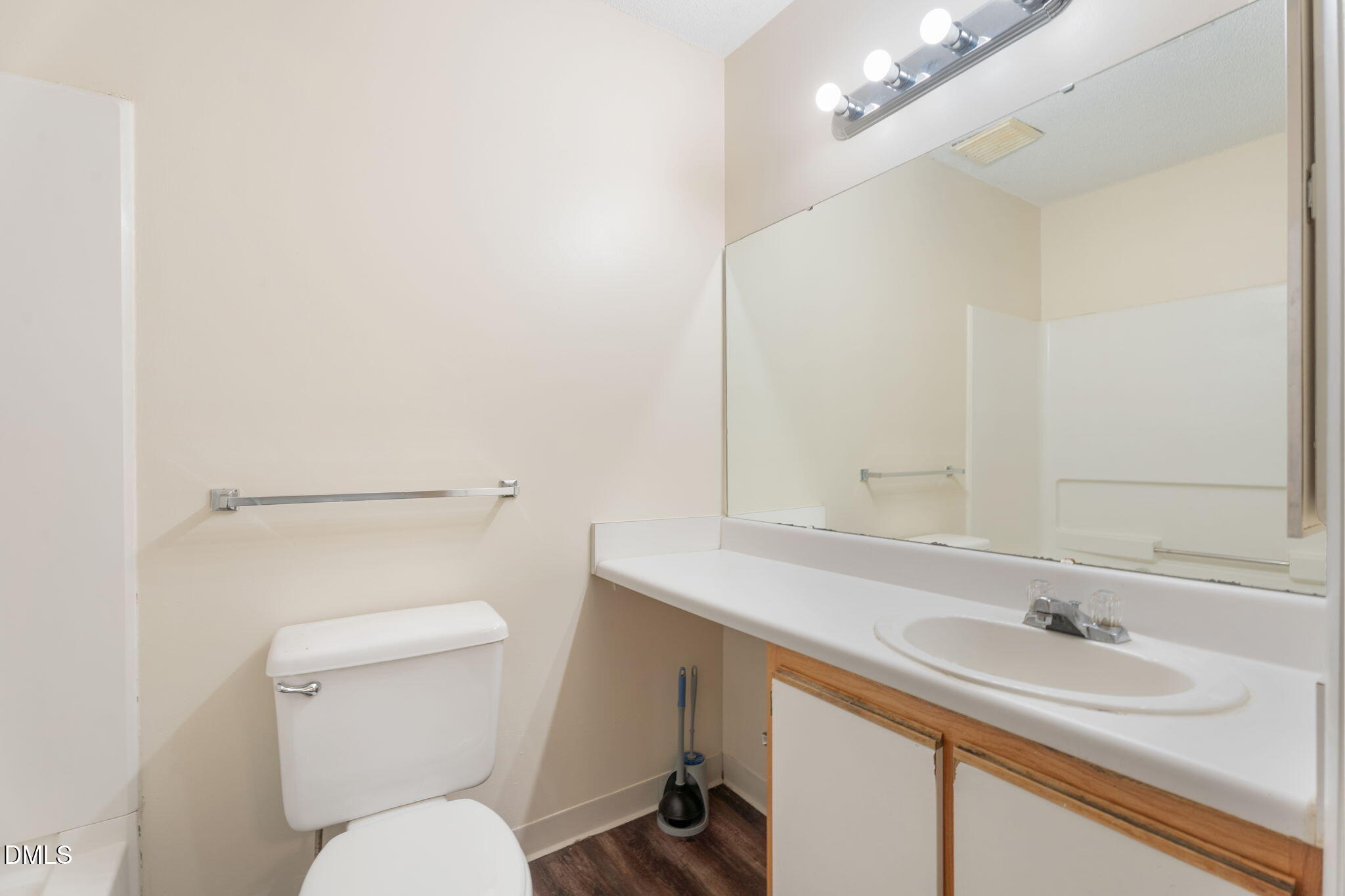1420 Collegiate Circle Raleigh, NC 27606 - Photo 24 of 30 a bathroom with a toilet a sink and mirror